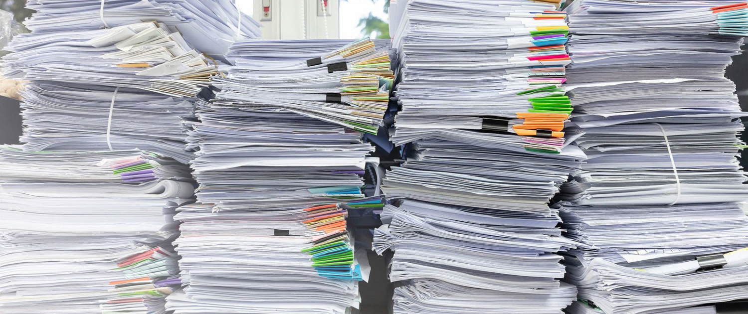 case-study-document-scanning-brisbane pile of documents on a table for document scanning